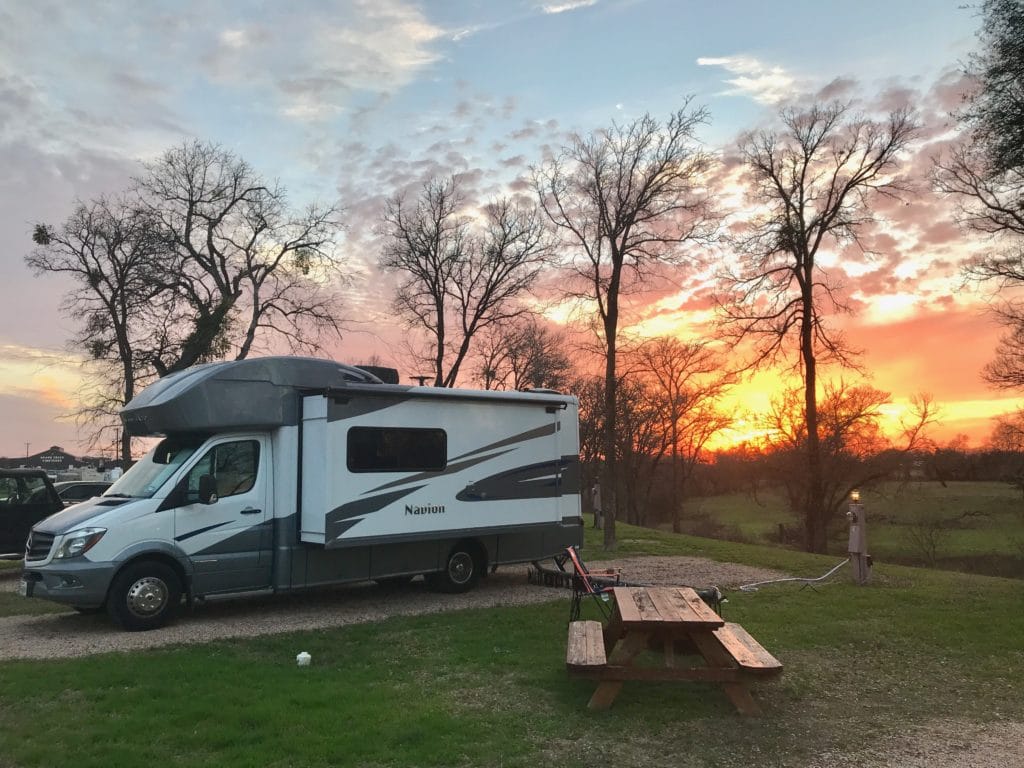 rv motorhome camped at an RV park with a beautiful sunset