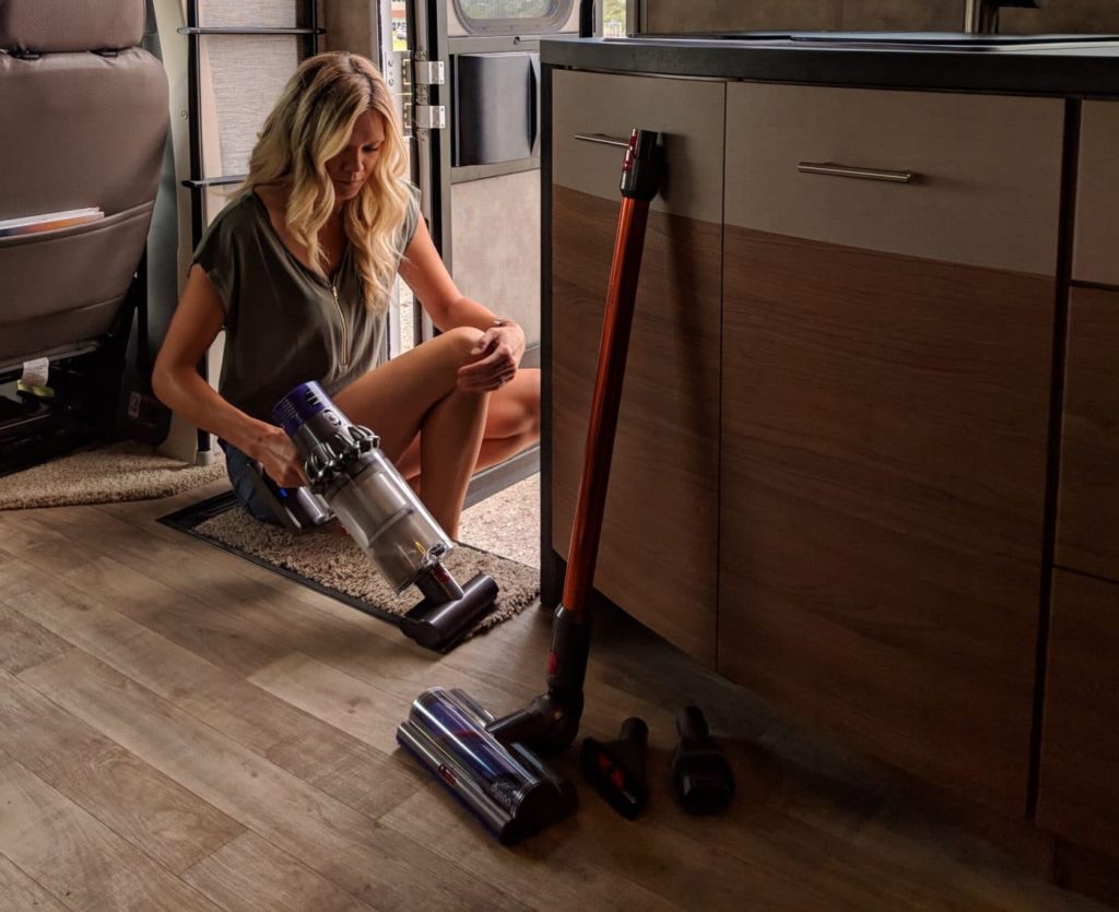 woman cleaning RV with Dyson Cyclone v10 vacuum