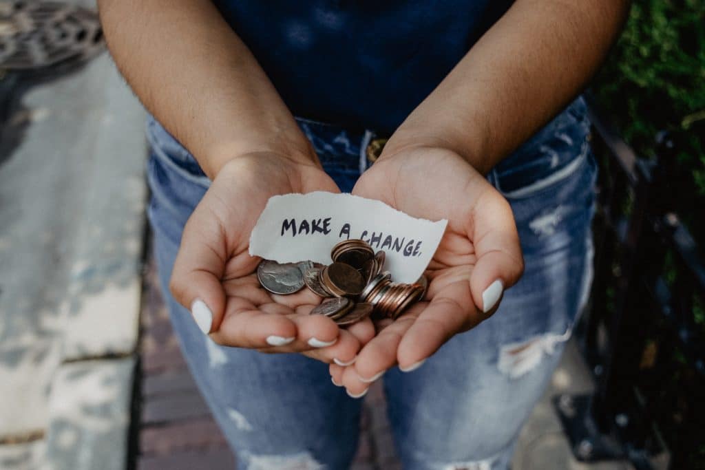 woman holding spare change in hands