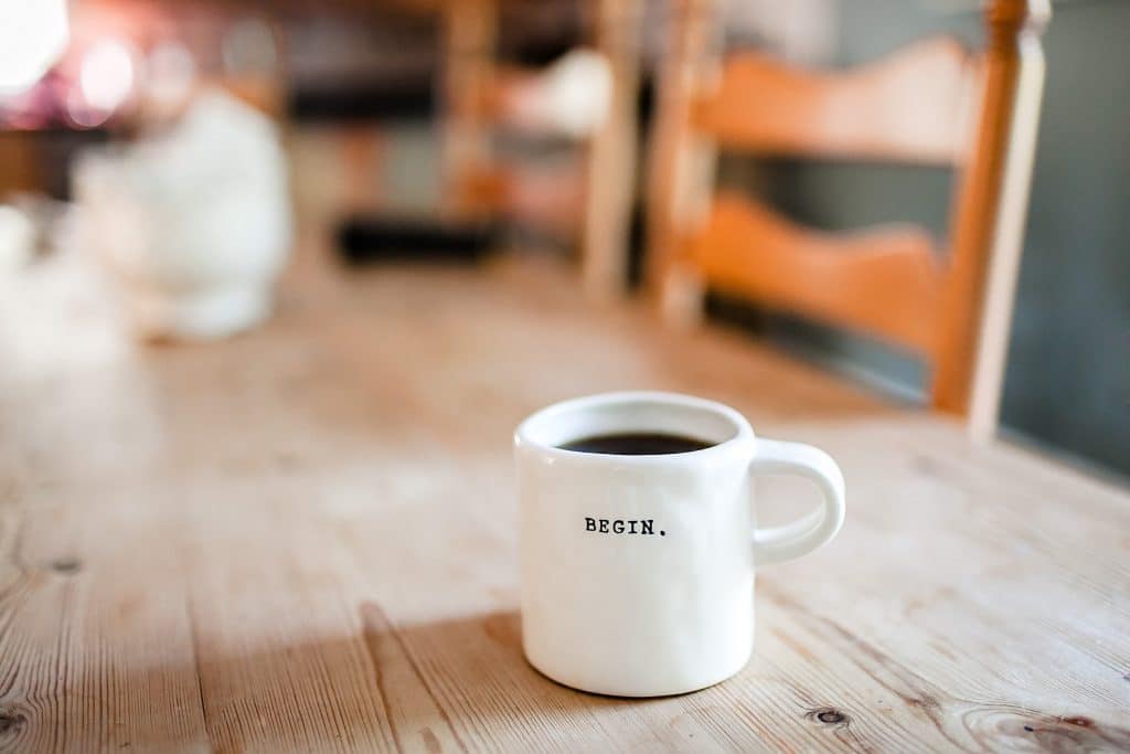 coffee mug with the word begin written on it