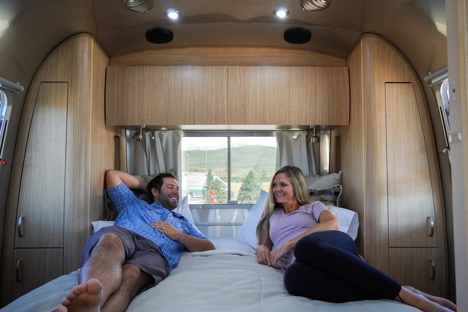 https://www.followyourdetour.com/wp-content/uploads/2022/01/Couple-laying-on-bed-in-cozy-RV-bedroom-e1642539879223.jpg